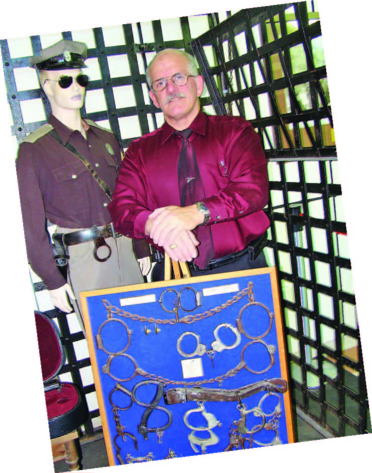Sheriff David Lain of Porter County, Ind., owns an extensive assortment of police antiquities that includes the handcuffs, come-alongs and leg chains pictured. He’s acquired them over the last 23 years through his own investigation and from friends. (Photo by Dee Dunheim)