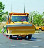 A Lake in the Hills driver correctly maneuvers his plow between two closely-spaced cones during the obstacle course competition.