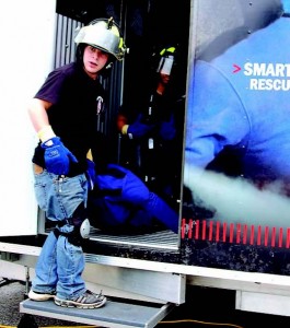 From left, Mitch Latta and Donivon Brummett exit a trailer at FDIC after retrieving their Smartdummy Rescue Manikin from a heavy smoke environment. The high school students attended the 2012 conference in Indianapolis as part of their Firefighting 1 and 2 studies. (Photo by Jodi Magallanes)