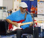 A harmonica blues player entertains for APWA attendees transitioning from the exposition hall to session classrooms at Lakeside Center, McCormick Place, Chicago. (Photo by Jodi Magallanes)
