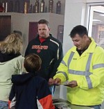 Captain Kevin Reather, left, and Assistant Chief Mark Thomas, both of the Norwood Young America, Minn., Fire Department, discuss fire safety and prevention with members of the public