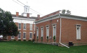 Pictured are the Knox County Courthouse, left , which will be receiving new windows that maintain its historic charm, and the Hall of Records in Knoxville, Ill. Both structures are listed on the National Register of Historic Places. (Public Domain via Wikimedia.org)