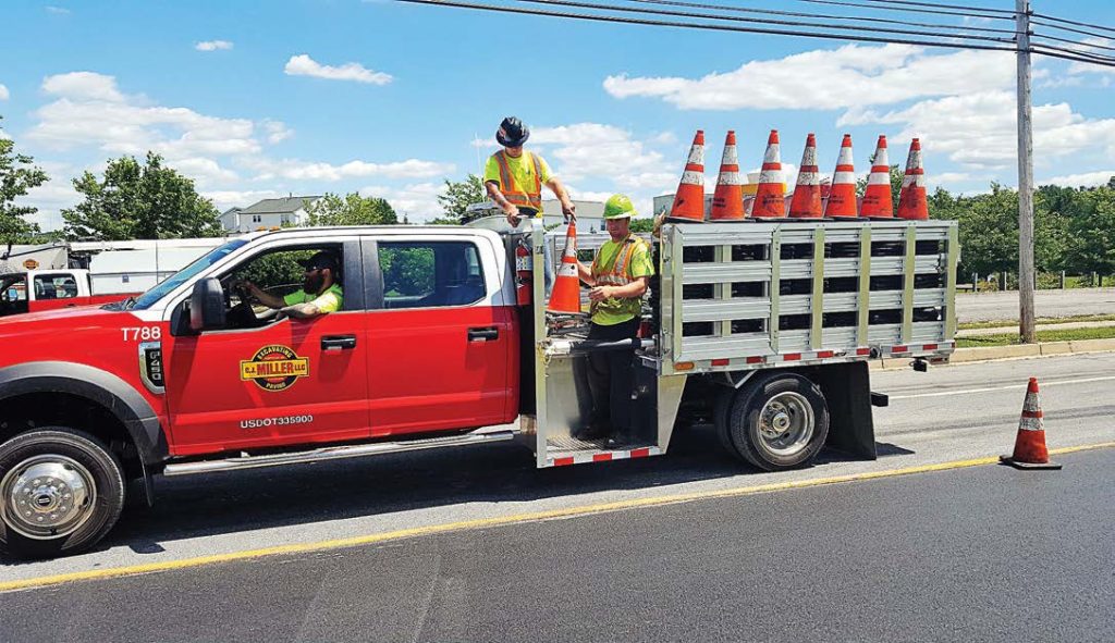 Workers place traffic cones from their stake body truck with a pulpit. EBY’s investment in state-of-the-art technology allows it to customized available options to fit specific needs. (Photo provided)