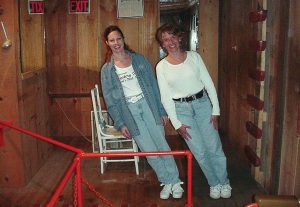 Two patrons of The Mystery Hole near Ansted, W.Va., seem to defy the normal laws of gravity. Whether natural laws are actually suspended or whether the room is just cleverly constructed is a question the attraction’s owners prefer to remain unanswered. (Photo provided)