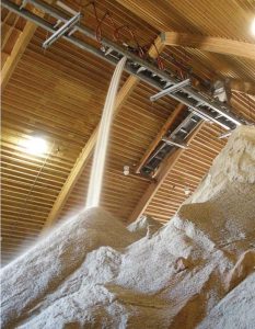 An inside view of the material storage facility, or “salt barn,” as it is fi lled with salt. The city has the capability of coating the salt with liquid product using the automated spray system. (Photo provided by the city of Fort Collins, Colo.)