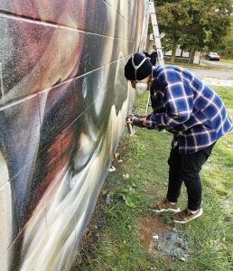Totem Books, the most recent mural site in Flint, Mich., is only one painted section of the city and has brought countless visitors already. Local and national artists have visited Flint to partake in the public art projects. (Photo provided)