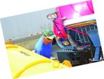 Joe Schroeder of Elgin, Ill., investigates an International snowplow belonging to Arlington Heights during the disabled vehicle portion of Thursday’s snowplow competition