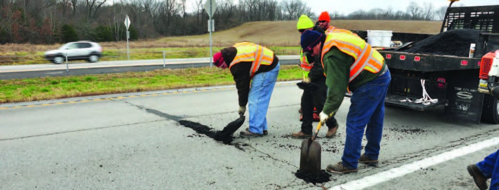 Members of the Lexington, Ky., Streets and Roads Department apply cold mix for an evaluation program