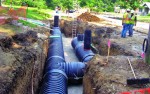 Below-grade storage chambers being installed along Troost Avenue