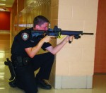 Officer Elliott Pedersen stands ready for action during the rapid deployment practice event in Plainfield, Ill.