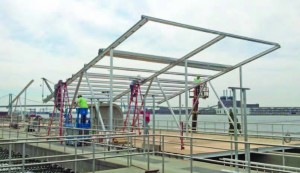 For the Camden project, modified carport racking was used to suspend the photovoltaic modules over the wastewater treatment tanks, providing a creative means of using space that had no other purpose. (Provided by groSolar)