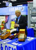 Charles Warner of Warner Plastics and Liners demonstrates the quality of the company’s dump truck liners at the 2013 Work Truck Show