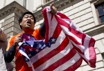 A man waves an American flag in honor of Boston Marathon