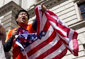 A man waves an American flag in honor of Boston Marathon