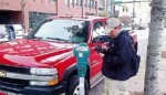 A parking ambassador writes a parking ticket prior to the installation of solar-powered meters in several locations around Chattanooga, Tenn. (Photo provided)