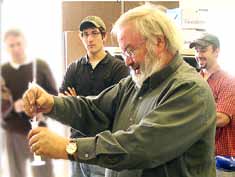 Another method of testing biodiesel fuel is the 3/27 test to gauge the quantity of glycerides — unconverted feedstock — that might be present in the fuel. The photo shows Rich Cregar checking a sample for glycerin for two of his biofuel technology students, Robert Harkins and Richard Sosnowski. (Photo provided)