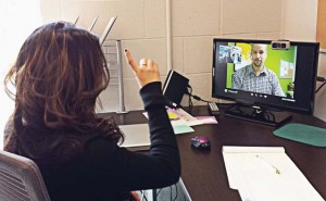 Dhrupal Patel, left, signs on the VRS screen with Mike Helms, director of Programs and Outreach at Bridges, a hearing-impaired assistance organization in Tennessee. (Photo provided)