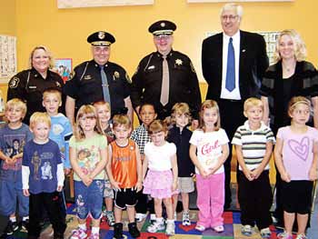 From left, Berrien County Sheriff’s Deputy Kelly Laesch, Chief Milton Agay, Berrien County Sheriff Paul Bailey and former Berrien County Prosecutor Arthur Cotter, now a judge, spent a day recently at Witheral School Day Care in St. Joseph, Mich. (Photo provided)