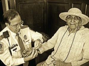 Project Lifesaver International Chief Operating Officer Tommy Carter does a monthly battery/bracelet change for a client. She wears a watch-sized transmitter. (Photo provided)