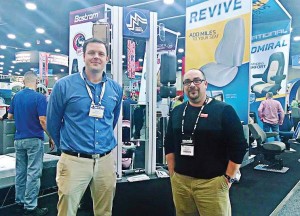 “The Road Ahead Begins at mats” was the theme of the 43rd annual Mid-America Trucking Show in Louisville, Ky. Pictured, from left, are Daniel Lewis of Commercial Vehicle Group Inc. and The Municipal Account Executive Chris Smith on the show floor. (Photo by Ashley Adamaitis)