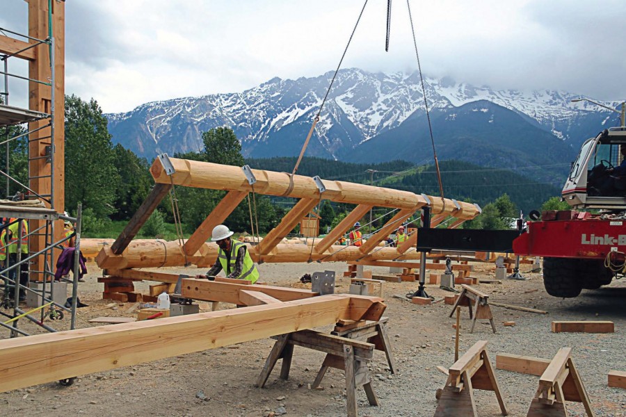 Portion of the barn is moved into place in May after being hand-hewn by members of the Timber Framers Guild, local craftsmen and apprentices. The nontraditional building method saved the town thousands in construction costs and gave residents a large measure of pride in the structure. (Photo provided)