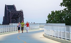 Pedestrians enjoy the Big Four Bridge one evening. The ramp was constructed to connect the community to the already existing bridge, and lighting was installed within the handrail in order to not overpower the surrounding historic residential neighborhood. (Photo provided by hntb Corporation)