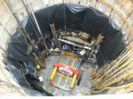 Construction crews place the tunnel boring machine in a pit adjacent to Lake Huron.