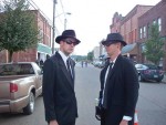Two “Men in Black” visitors to the Mothman Festival in Point Pleasant, W.Va., last year came prepared to eradicate the fi ctional threat celebrated by the town each September. (Photo provided)