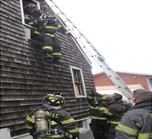 NEXT: The outside team uses the ground ladder like a brake bar rack to lower the firefighter to the ground (Photo provided).