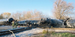 Members of the Watertown Fire Department spray down derailed cars of the Canadian-Pacific train in November