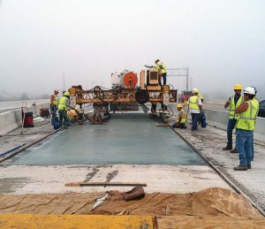 Contractors hand-level the concrete as they complete the bridge deck overlay on the I-69/SR 1 project in Fort Wayne, Ind. (Photo provided by INDOT)
