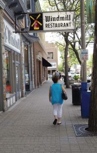 A visitor to downtown Holland, Mich., strolls down a sidewalk along Eighth Street, one of the first sections of heated sidewalks. (Photo by Denise Fedorow)