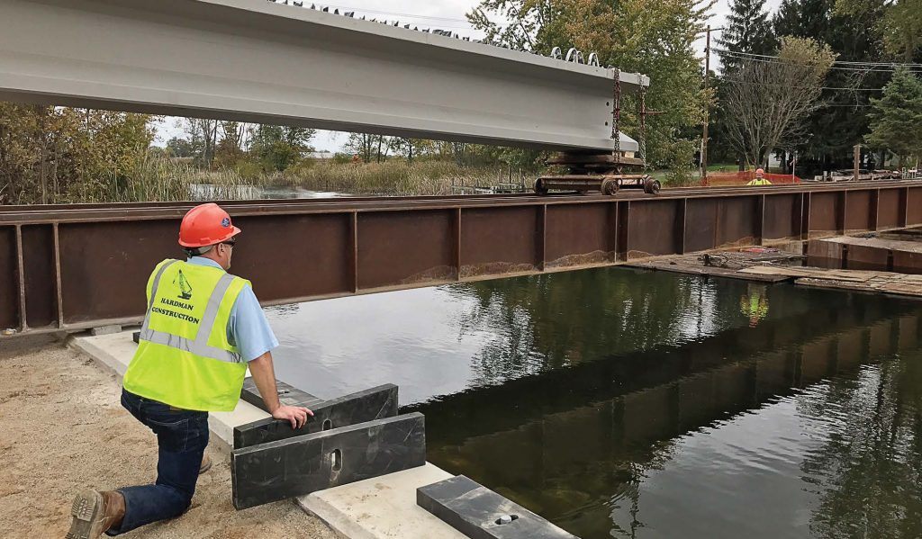 Workers get ready to place one of the new bulb T-beams at the M-86 bridge project site. The new M-86 bridge will be one of only two bridges in Michigan to feature the innovative bulb T-beams. (Photo provided)