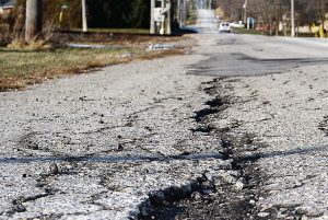 Budget crises and maintenance costs are driving some cities and counties to eye different approaches when it comes to crumbling roads, including reverting back to gravel. (Shutterstock.com)