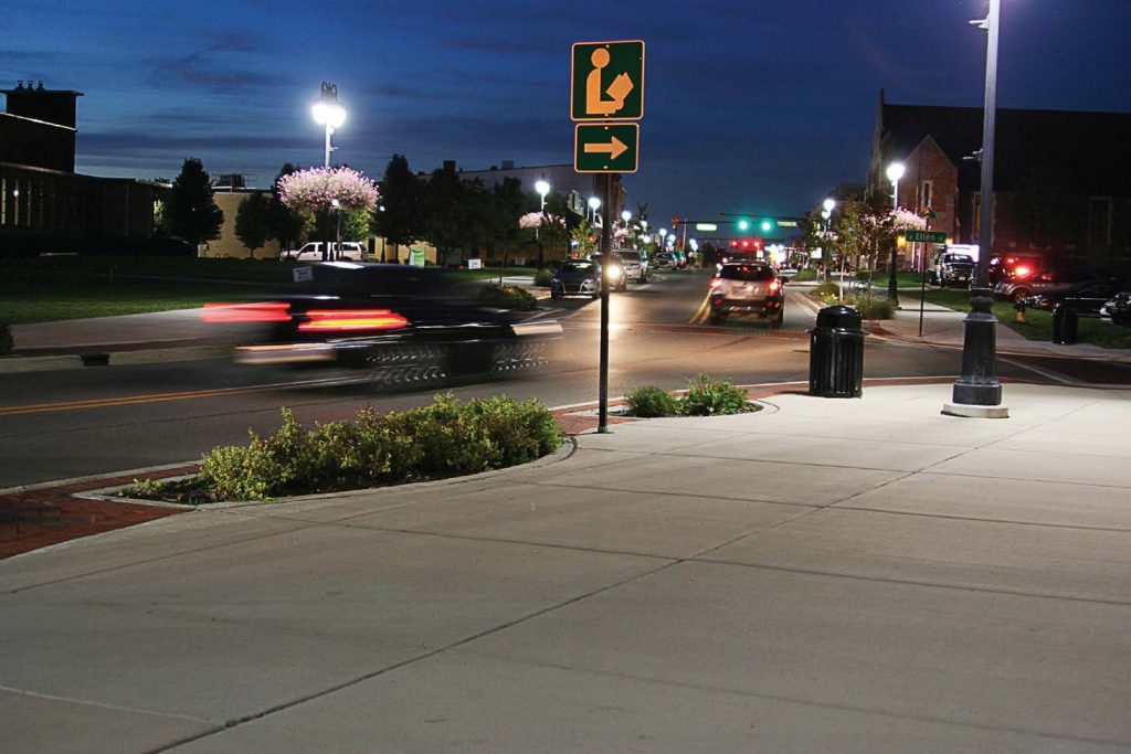 Vehicles travel through downtown Fenton as the city’s new streetlights illuminate the area. (Photo provided)