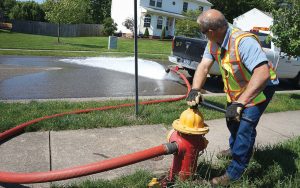 Local governments often have more of an impact on daily lives of citizens, through maintaining necessary infrastructure. Pictured, a Cranberry Township employee flushes a fire hydrant. (Photo provided)