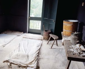 The patients’ room at Pest House was painted black to alleviate light sensitivity in smallpox patients and white sand was used to trap germs. After each patient’s stay, the sand was swept out the door. (Photo provided by Ted Delaney)