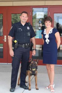 Kurovski hopes to help Pleasant Hill continue its high level of public safety services by building a new public safety facility. Here she stands with a local officer and his K-9. (Photo provided)