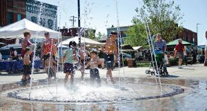 Kids play in the fountain at Stevens Point’s farmer’s market. (Photo provided by KT Elements)