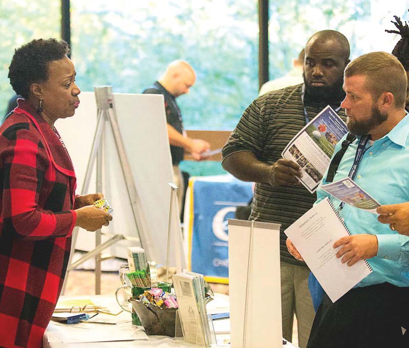 Employees talk with Keep Columbus Beautiful Executive Director Gloria Weston Smart about a program to reduce litter at an Up and Motivated conference