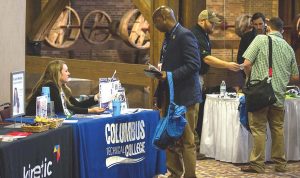 A public works employee checks out some college opportunities at an Up and Motivated conference. (Photo provided)