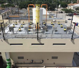 In order to optimize the contactor format, Boynton Beach used computation fluid dynamics. This means it used counterrotating mixers without baffle stators in order to minimize rotation. The top of an ion exchange contactor is shown with mixer motors and resin transfer tank. (Photo provided)