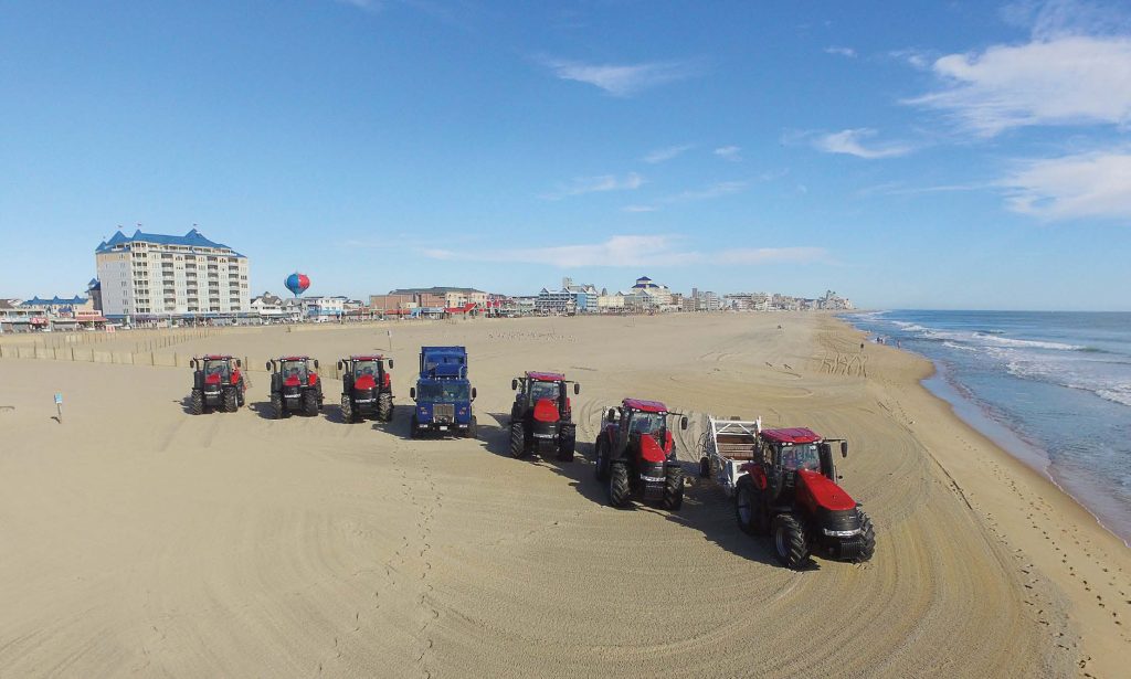 Red beach cleaners and a blue beach trash truck comb a Ocean City, Md., beach. The city has a fuel depot with four underground storage tanks and several contingency plans ready should a disaster — whether man-made or natural — disrupt fuel from reaching the island. (Photo provided)
