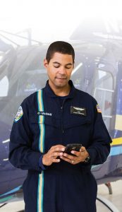 Phil Nicolas, a 21-year-old paramedic with LifeLink III, is pictured near one of the flight service’s six AgustaWestland 119Kx helicopters at his base in Anoka, Minn. LifeLink III has found tracking schedules, swapping shifts and supervisor-staff communication to be easier with the Aladtec workforce management system.(Photo provided)