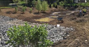 Construction of the created wetland in Albany was ongoing in this photo and water was already starting to collect. The wetland was part of a two-part solution to mitigate flooding in a neighborhood of the city that fell victim many times to “horrific flooding.” The city also installed an underground detention gallery under a baseball field in the neighborhood. (Photo provided)