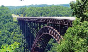 The New River Gorge Bridge, one of the world’s longest and highest steel arch bridges, spans the New River in the Appalachian Mountains a few miles southeast of The Mystery Hole. (bobistraveling via Flickr, creativecommons.org/licenses/by/2.0/)
