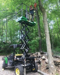 Attached to a John Deere Gator, this UTX is used to perform forestry work. With its easy-touse adaptors, the UTX Scissor Lift can be shared across city departments. (Photo provided)