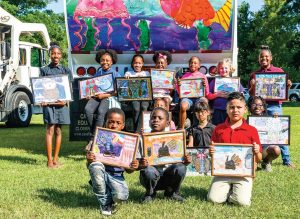 Winners of the “Keep the Green in Greenville” poster competition for young pupils in Pitt County pose with their paintings. Paintings were then enlarged and placed on sanitation trucks to increase awareness of environmental concerns. (Photo provided)