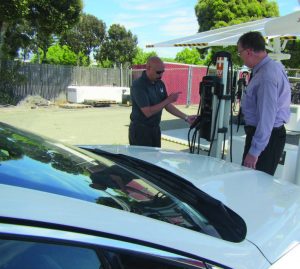 From left, Jason Chin, Oakland’s fleet compliance coordinator, and Richard Battersby, interim assistant director of Oakland’s bureau of infrastructure and operations, check out one of the EV ARC self-contained, solar-powered Level 2 charging stations. Electric cars charged at it will be using 100 percent renewable fuel. (Photo provided)