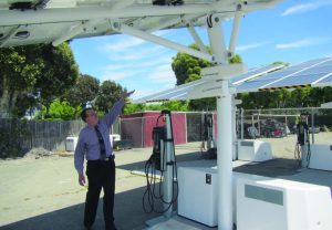 Interim Assistant Director of the Bureau of Infrastructure and Operations Richard Battersby feels the benefits of solar energy. While the units are expensive, they do guarantee that electric vehicles charged there are using 100 percent renewable energy. (Photo provided)